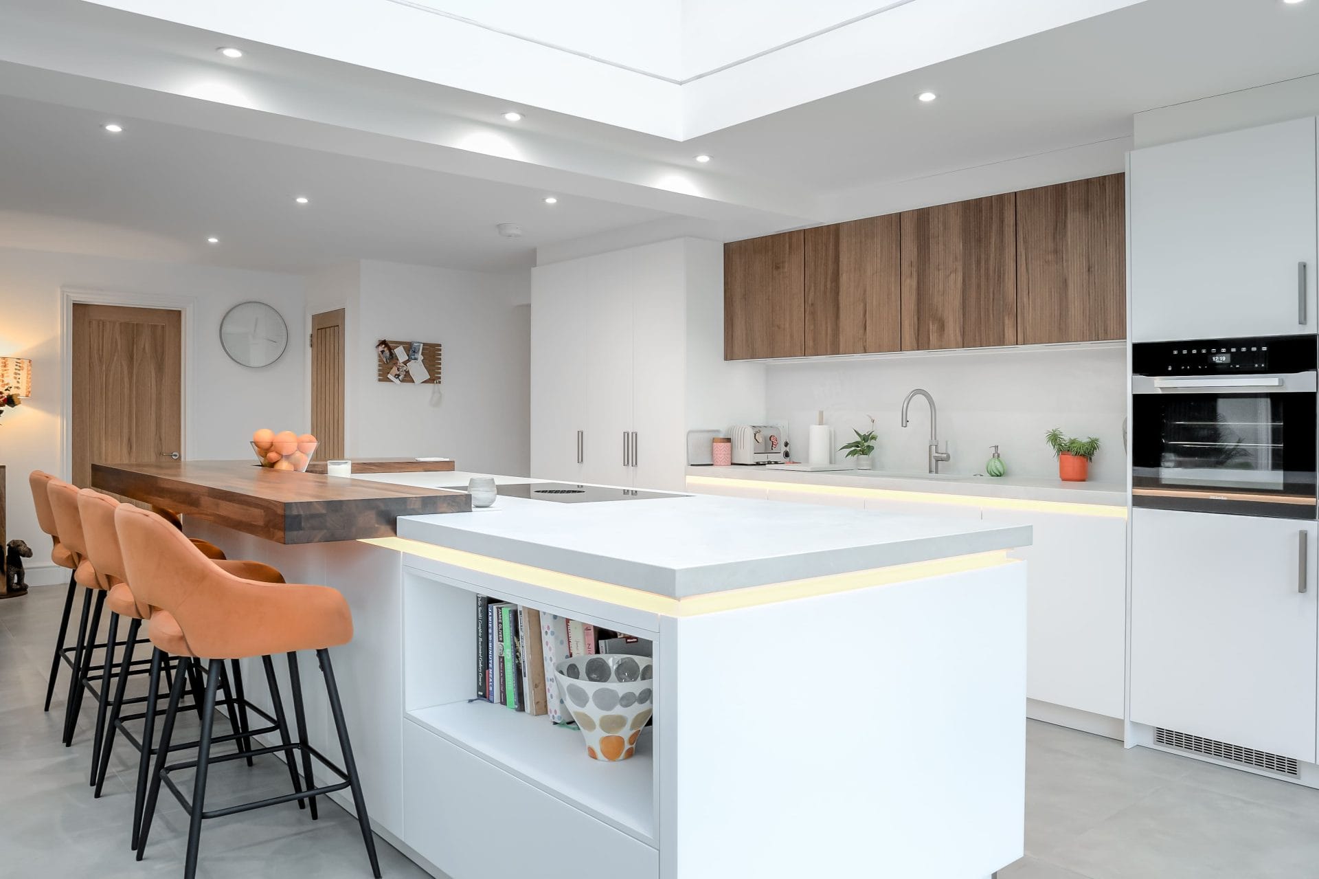 Open plan kitchen with large island, breakfast bar seating and integrated lighting for everyday living